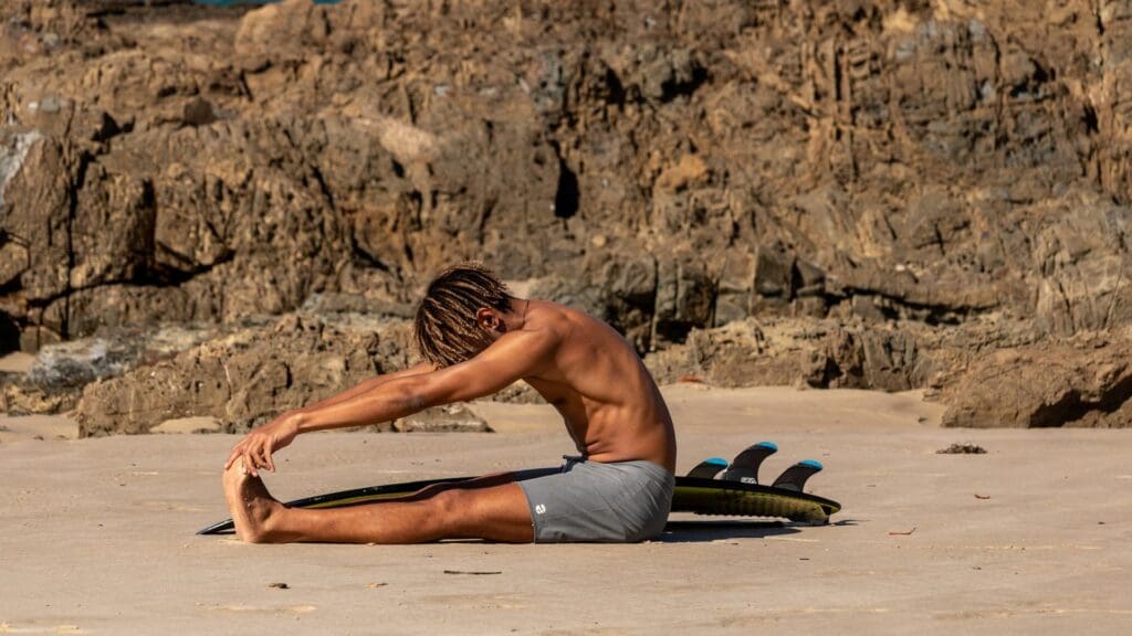man doing meditation on beach