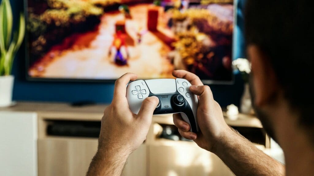 man playing playstation videogames