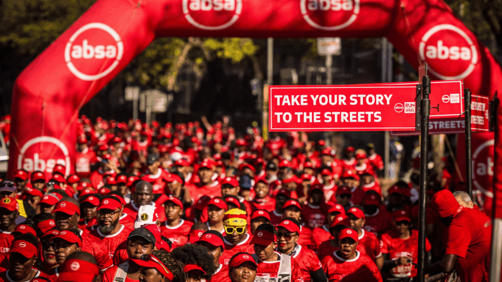 : A sea of red takes over the streets of Tshwane at the Absa RUN YOUR CITY TSHWANE 10K on Sunday 24 August 2025. PHOTO CREDIT: Tobias Ginsberg