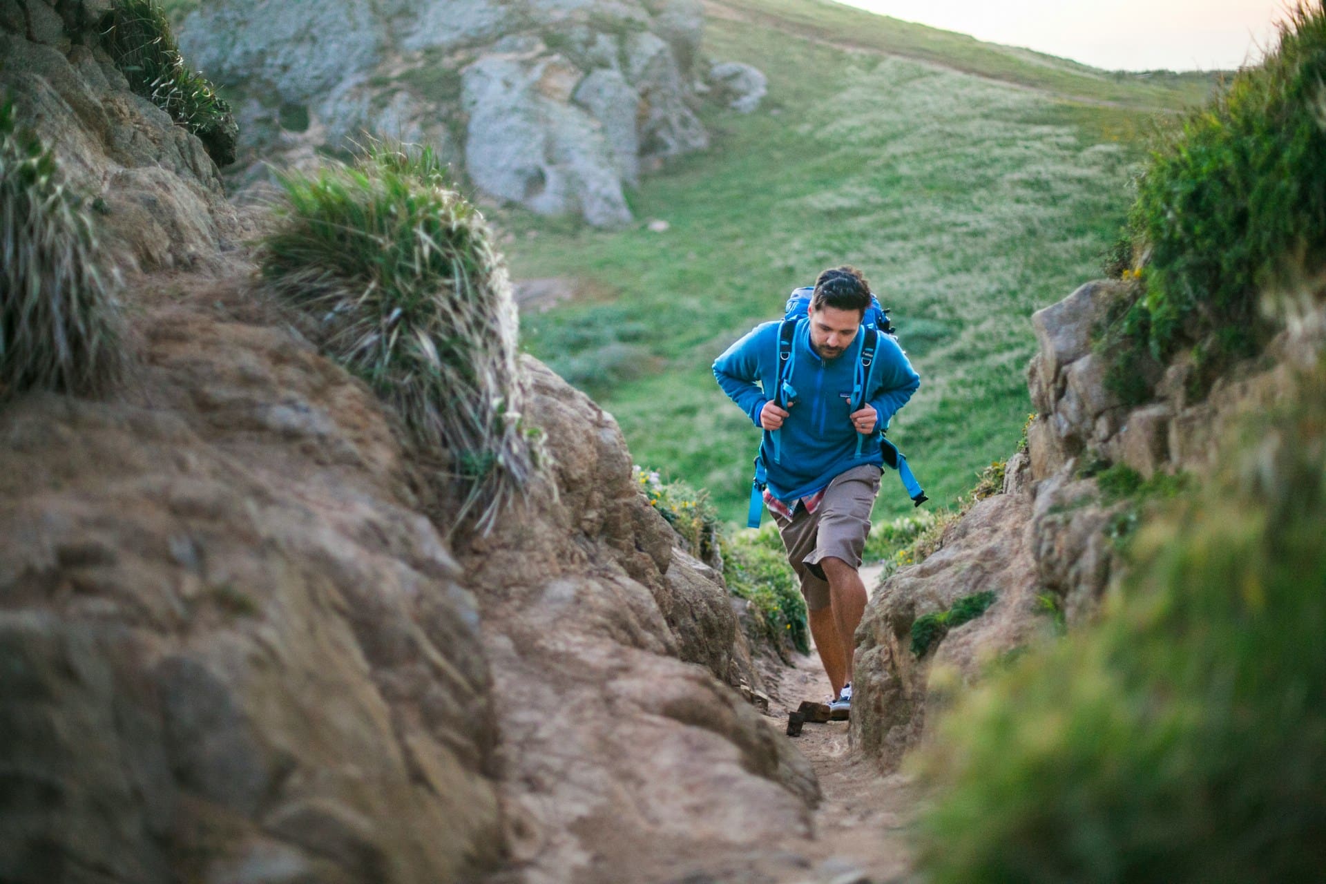 man running in nature ascending a mountain