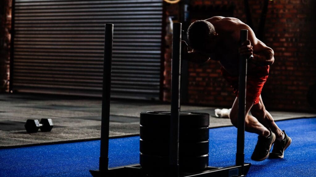 francois griesel doing sled push in the gym