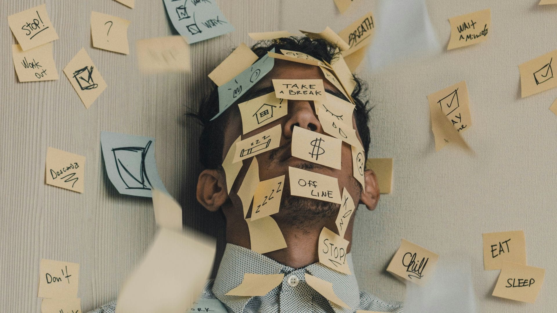 calmer mind FEAT man with face covered in post-it notes of different stressors