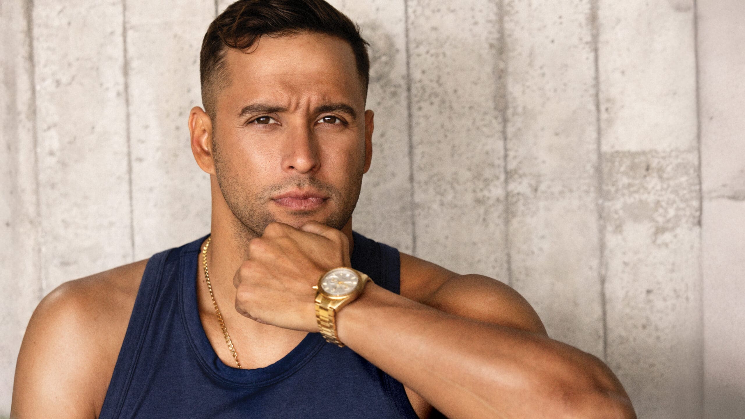 portrait of olympic champion chad le clos posing in front of wall with gold watch